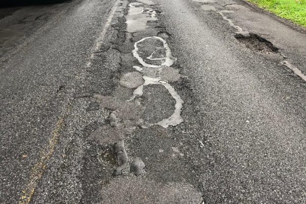 River Road in Muhlenburg Township had no cross slope, and most of the roadway was flat. The center joint had cracked and had been patched with hot mix asphalt on many occasions. In some areas, new potholes are evident.